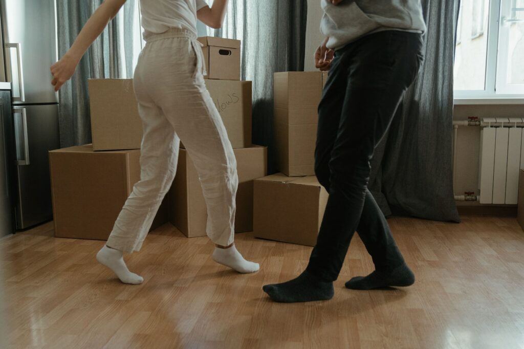 Umzug Menschen tanzen vor Freude auf die neue Wohnung Worauf man bei der Wahl eines Umzugsunternehmens achten sollte